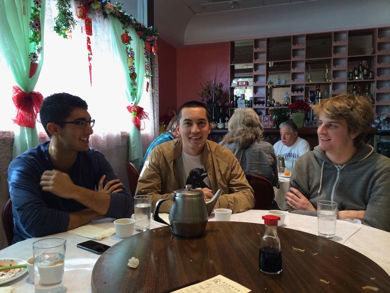 Armon Dadgar, Mitchell Hashimoto, and Jack Pearkes at a restaurant table
